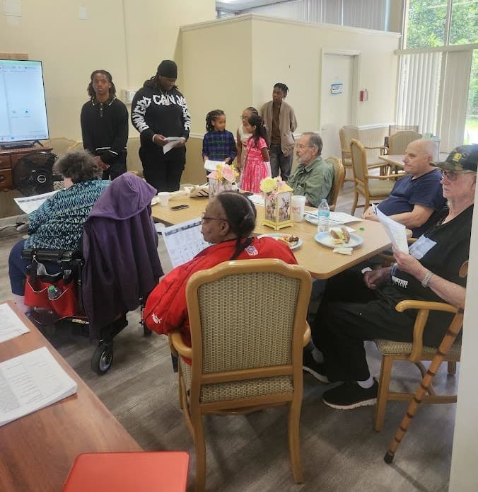 DRMI Geeks and Gramps session with participants gathered around tables.